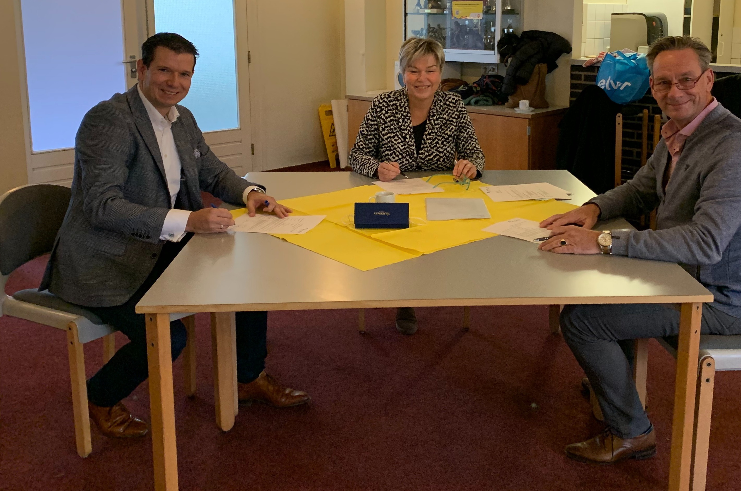 Officiële ondertekening oplevering installatiefase 1 Elver in Arnhem-Noord met vlnr: Derk Wassink (algemeen directeur Wassink Installaties), Irma Harmelink (Raad van bestuur Elver), Marco de Pijper (M-trix Installatie Adviseur)